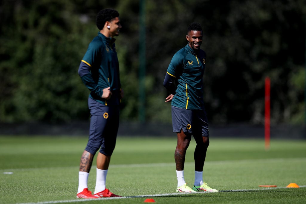 Nelson Semedo (R) and Ki-Jana Hoever of Wolverhampton Wanderers look on during a Wolverhampton Wanderers Training Session at Sir Jack Hayward Training Ground on August 26, 2021 in Wolverhampton, England.