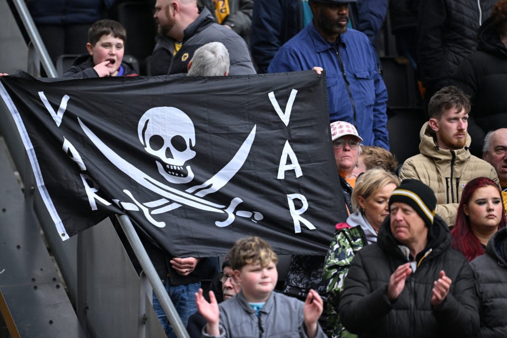 Wolves fans display a flag with an anti-VAR message in the crowd ahead of the English Premier League football match