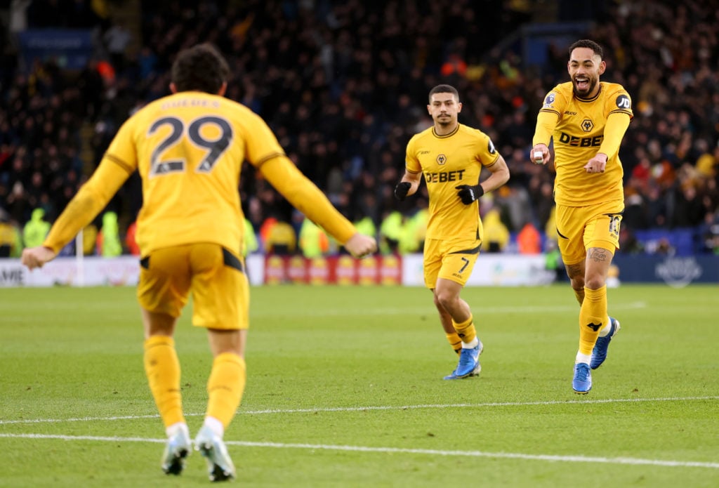 Matheus Cunha of Wolverhampton Wanderers celebrates scoring his team's third goal with teammate Goncalo Guedes during the Premier League match between Leicester City FC and Wolverhampton Wanderers FC at The King Power Stadium on December 22, 2024 in Leicester, England