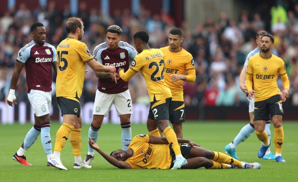 Yerson Mosquera of Wolverhampton Wanderers reacts on the floor with a injury during the Premier League match between Aston Villa FC and Wolverhampton Wanderers FC
