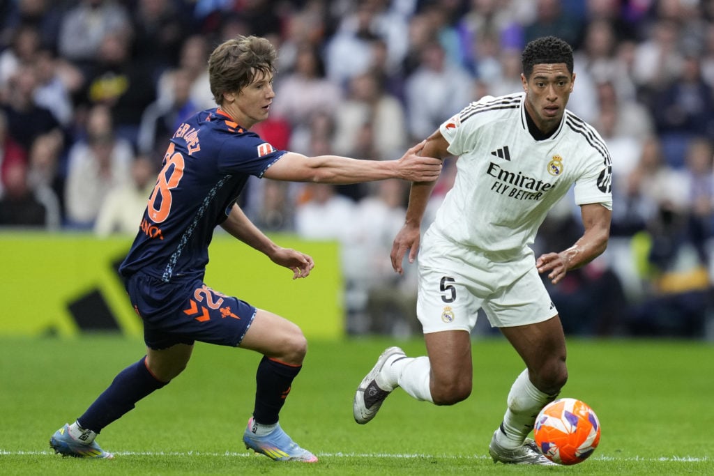 Fer Lopez of Celta Vigo jostling with Real Madrid's Jude Bellingham