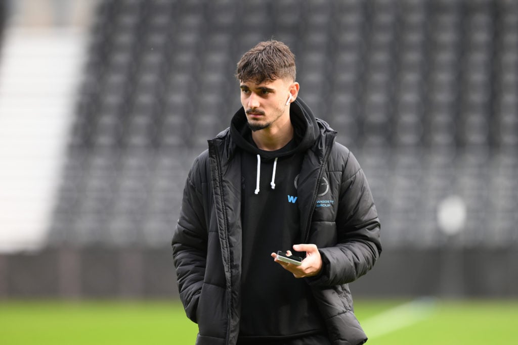 Millwall striker Mihailo Ivanovic on his phone.