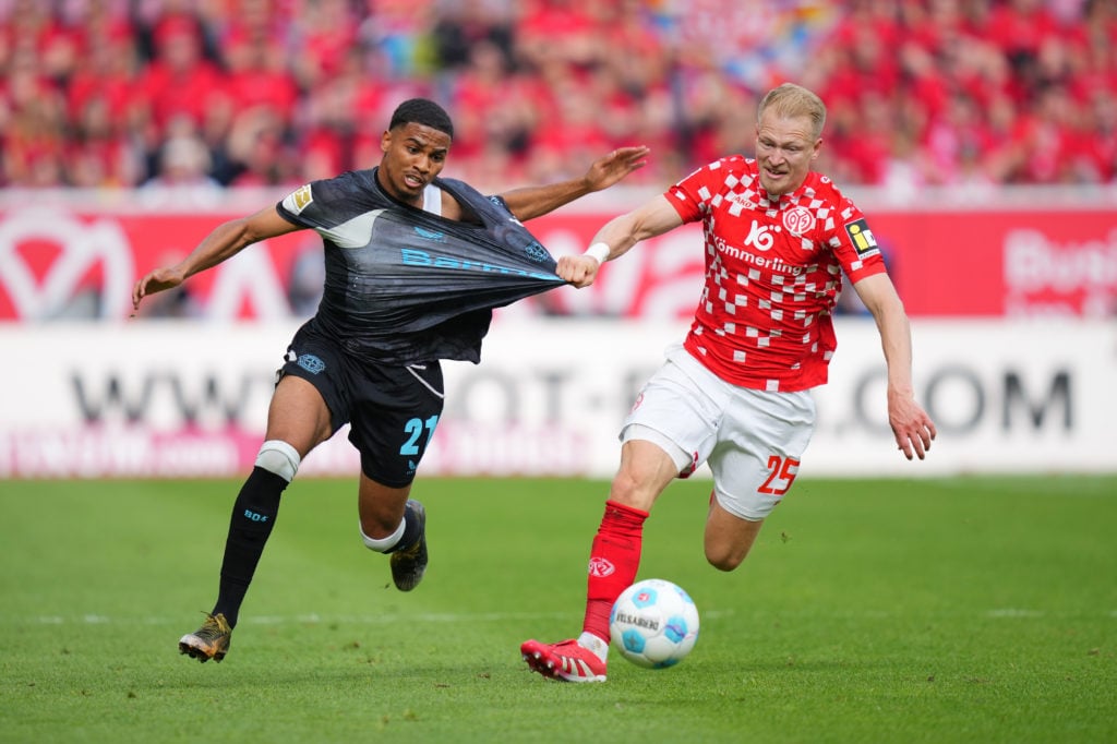 Amine Adli jostles for possession of the ball.