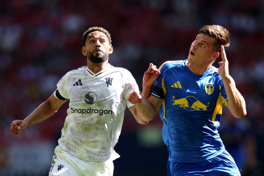 Matheus Cunha duels with Jaka Bijol during Manchester United v Leeds United