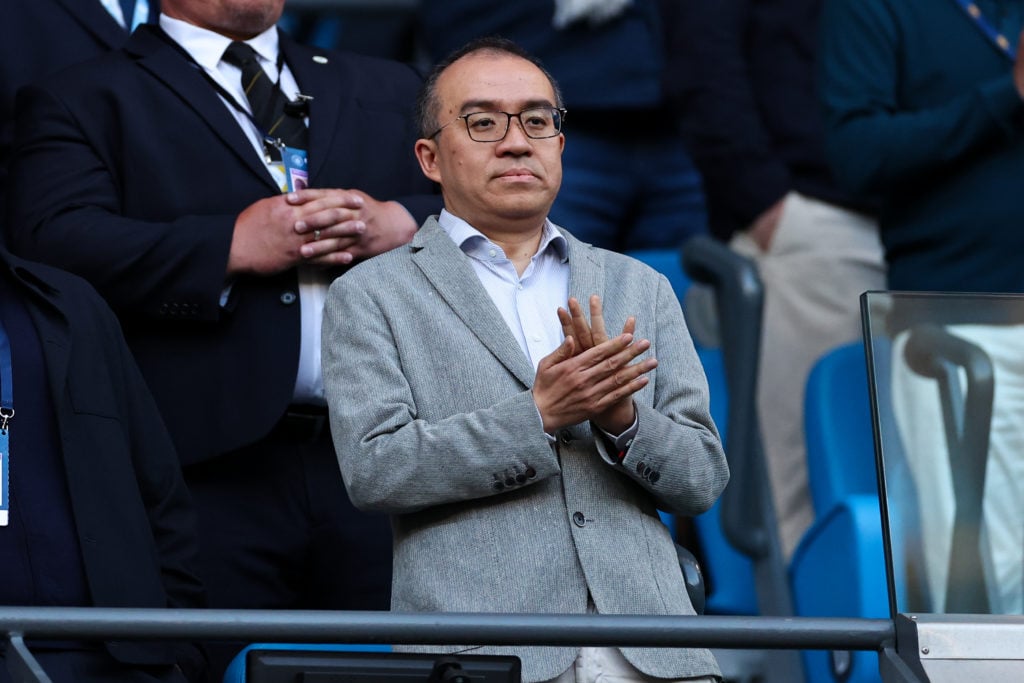 Wolves chairman Jeff Shi applauds.