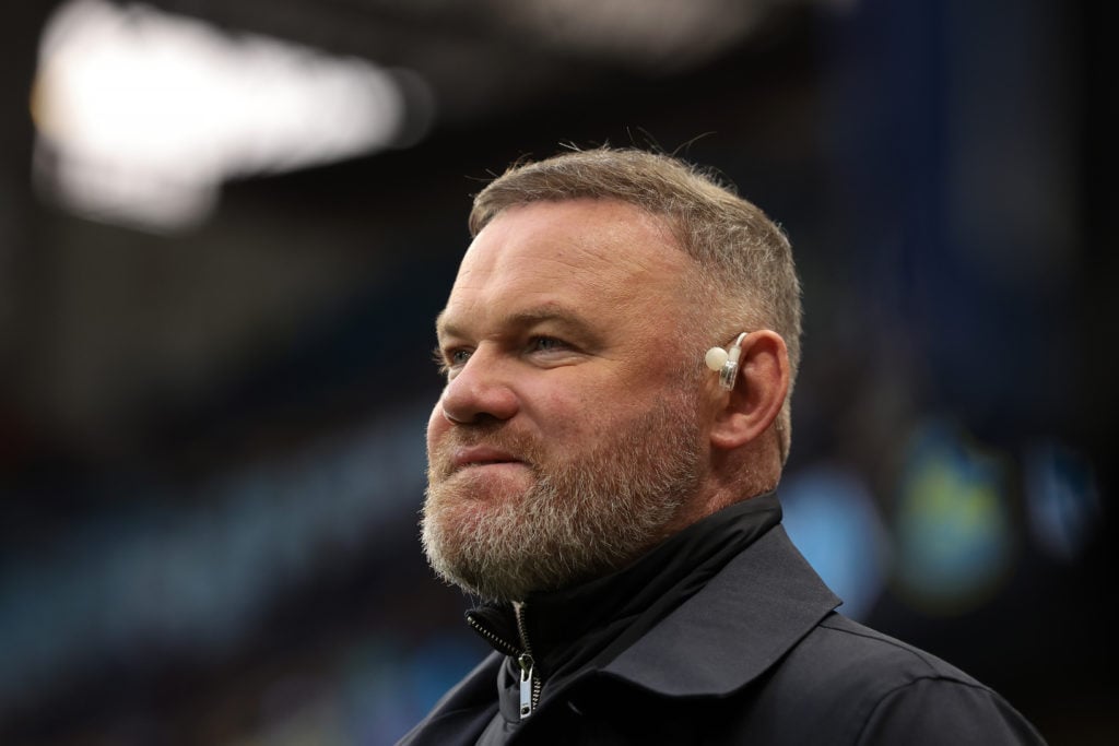 Pundit Wayne Rooney looks on.