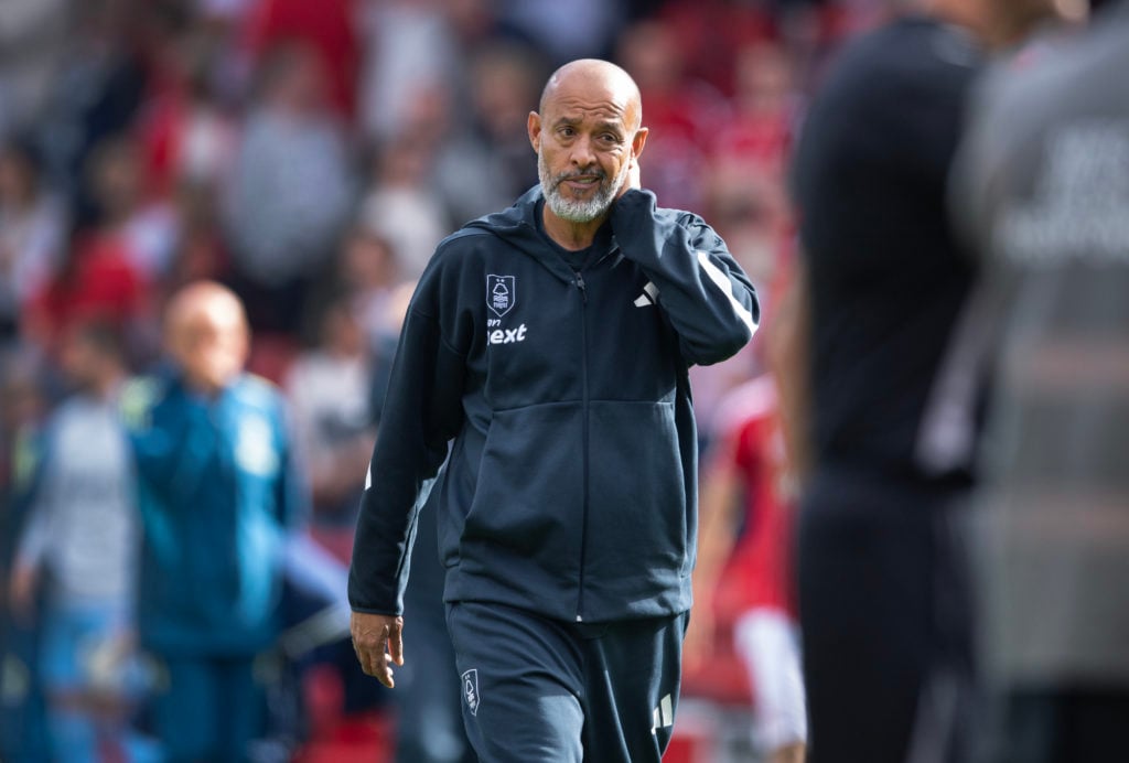 Nuno Espirito Santo puts his hand on his neck.