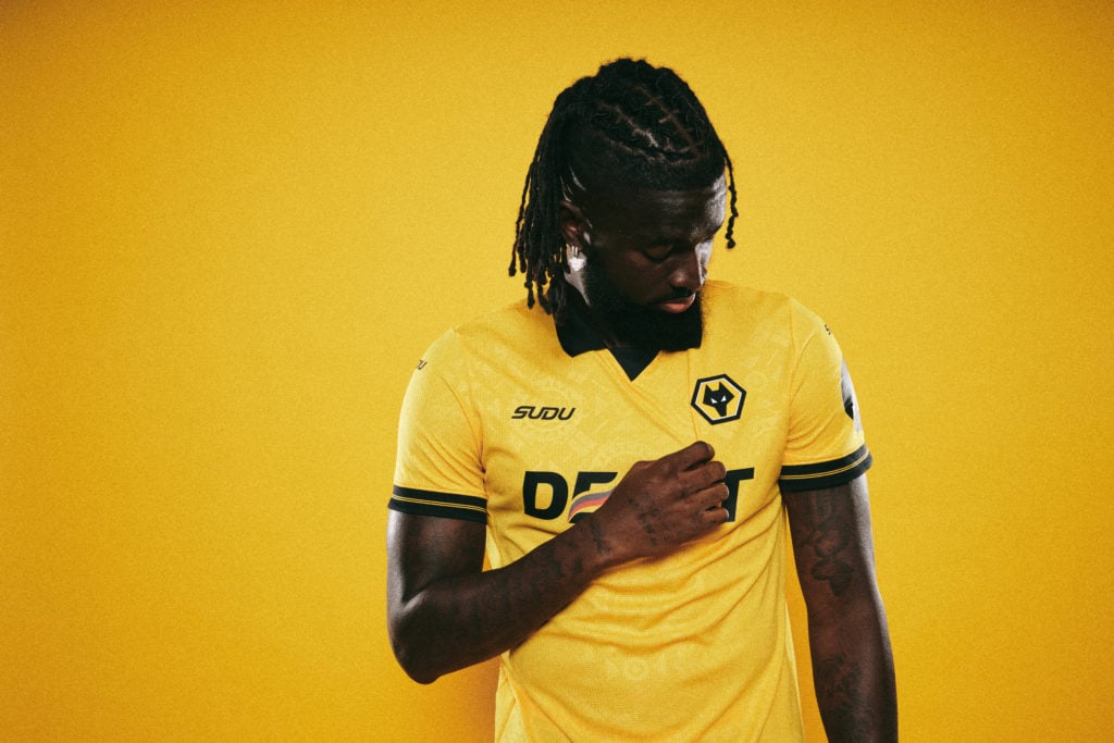 Tolu Arokodare wearing a Wolves shirt after signing for the club.