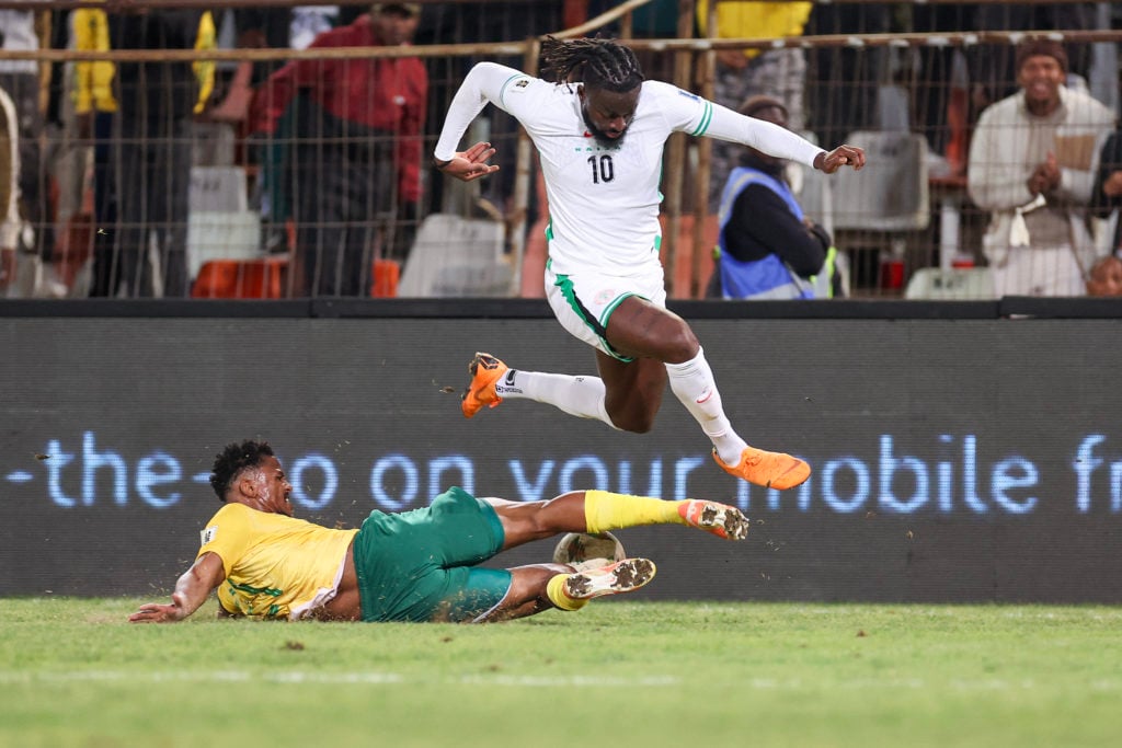 South Africa's defender #21 Siyabonga Ngezana (L) tackles Nigeria's forward #10 Tolu Arokodare (R) during the FIFA World Cup 2026 Africa qualifiers group C match between South Africa and Nigeria at the Free State Stadium in Bloemfontein on September 9