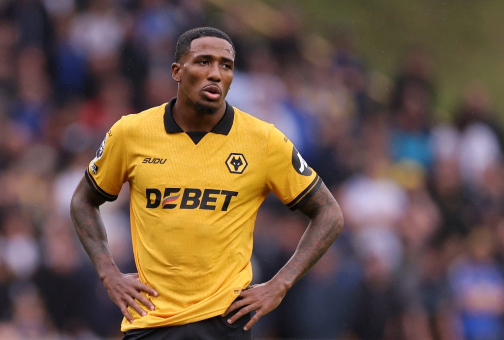 Jackson Tchatchoua puts his hands on his hips while playing for Wolves.
