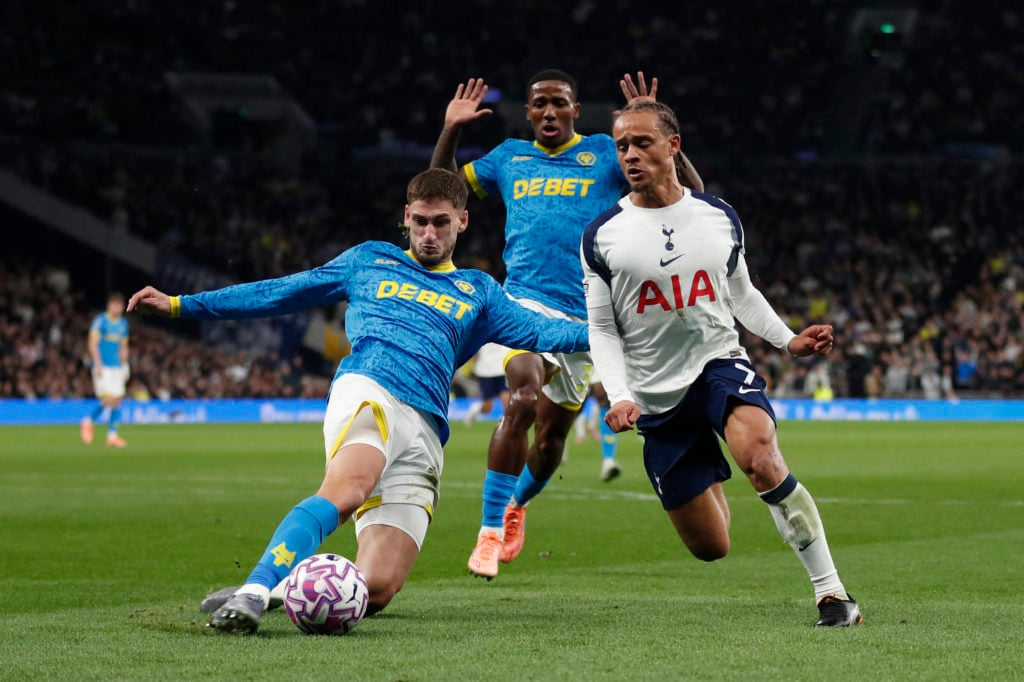 Wolves defender Santiago Bueno tackling Tottenham's Xavi Simons