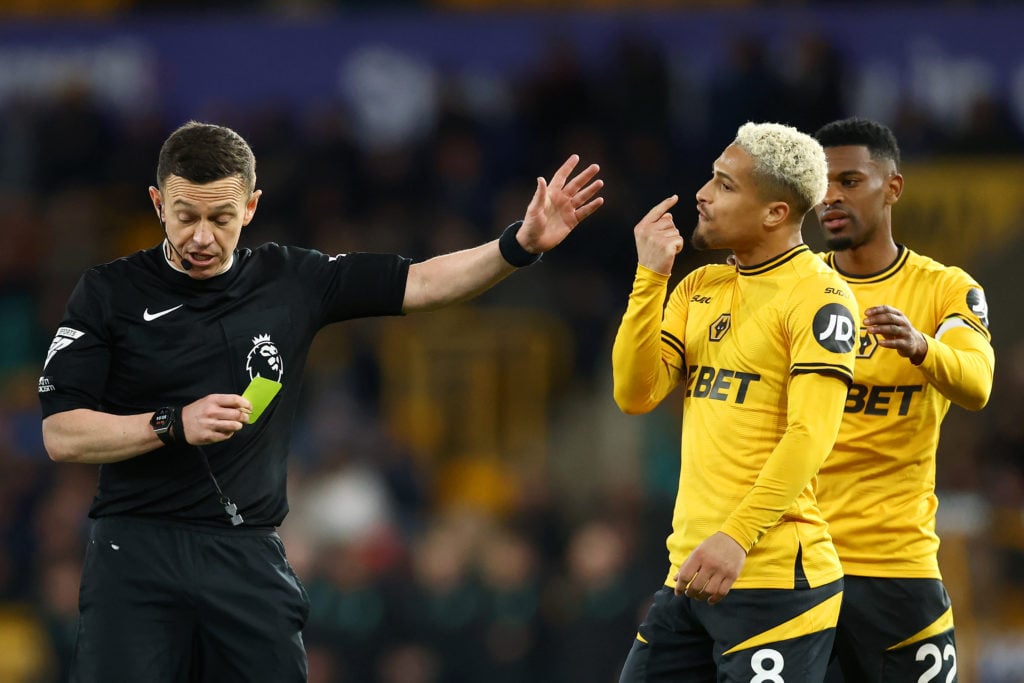 Joao Gomes gets a yellow card for Wolves.