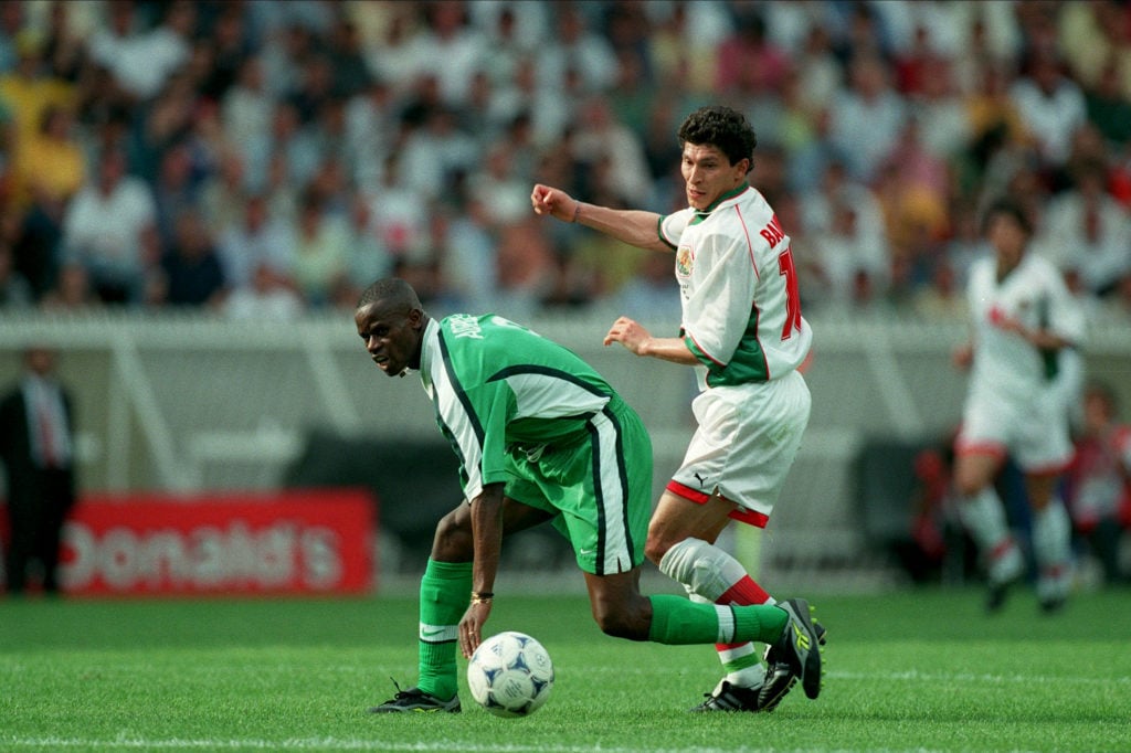 Mutiu Adepoju of Nigeria and Krassimir Balakov of Bulgaria challenge during the FIFA World Cup Finals