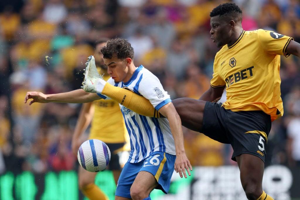 Yasin Ayari of Brighton and Hove Albion and Marshall Munetsi of Wolverhampton Wanderers challenge