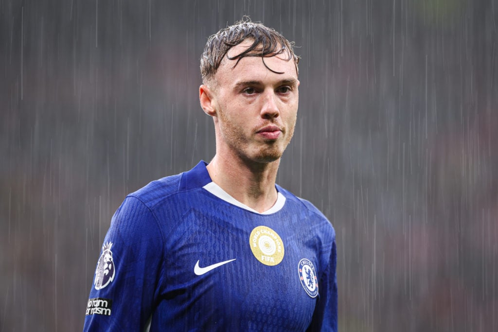 Cole Palmer of Chelsea looks on in the pouring rain during the Premier League match between Manchester United and Chelsea