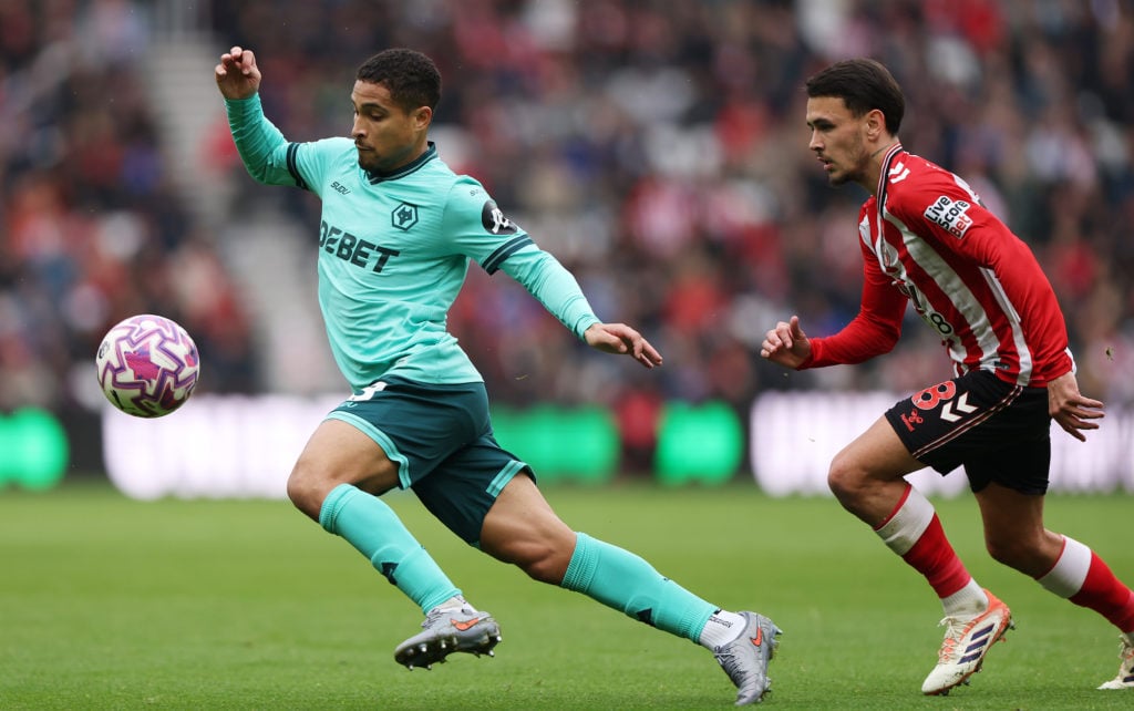 Joao Gomes of Wolverhampton Wanderers runs with the ball whilst under pressure from Enzo Le Fee of Sunderland during the Premier League match between Sunderland and Wolverhampton Wanderers