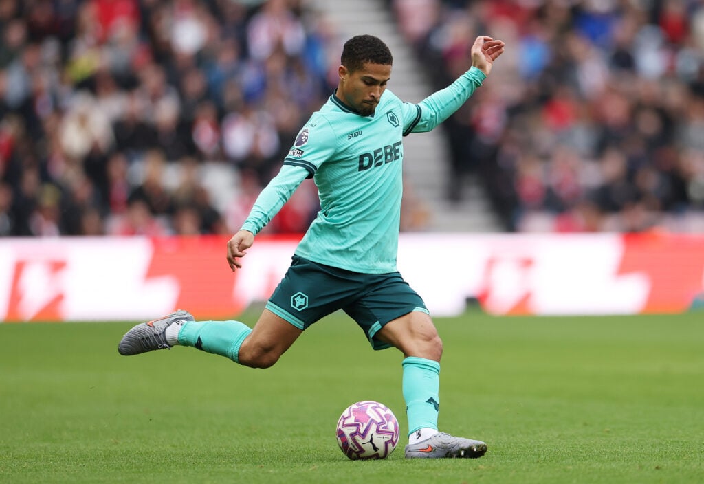 Joao Gomes plays a pass for Wolves.