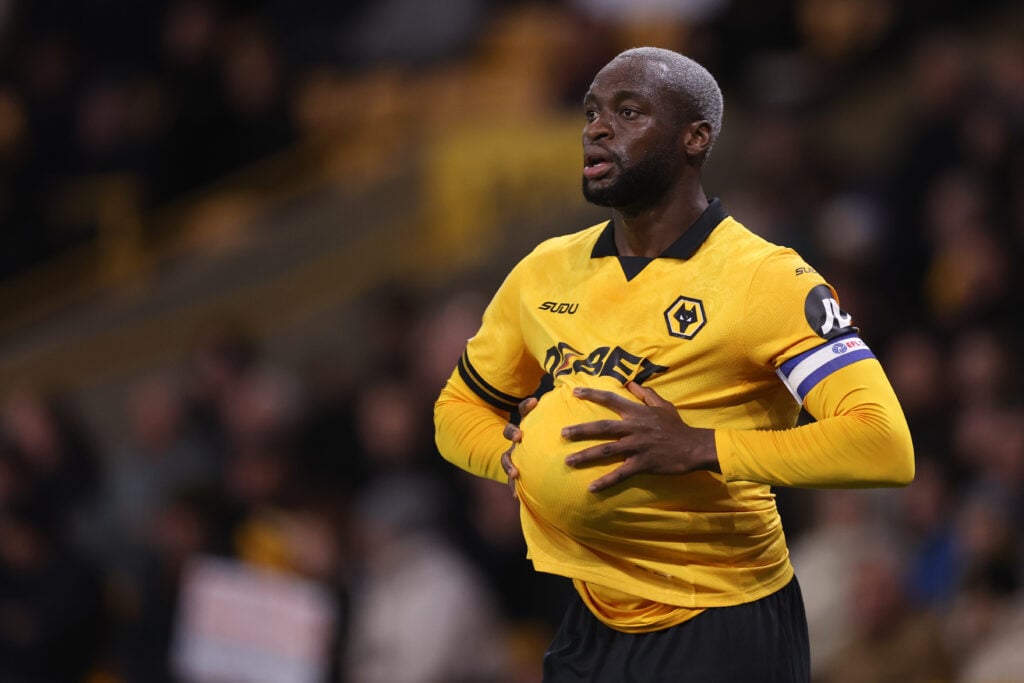 Toti Gomes dries the ball while taking a throw in for Wolves.