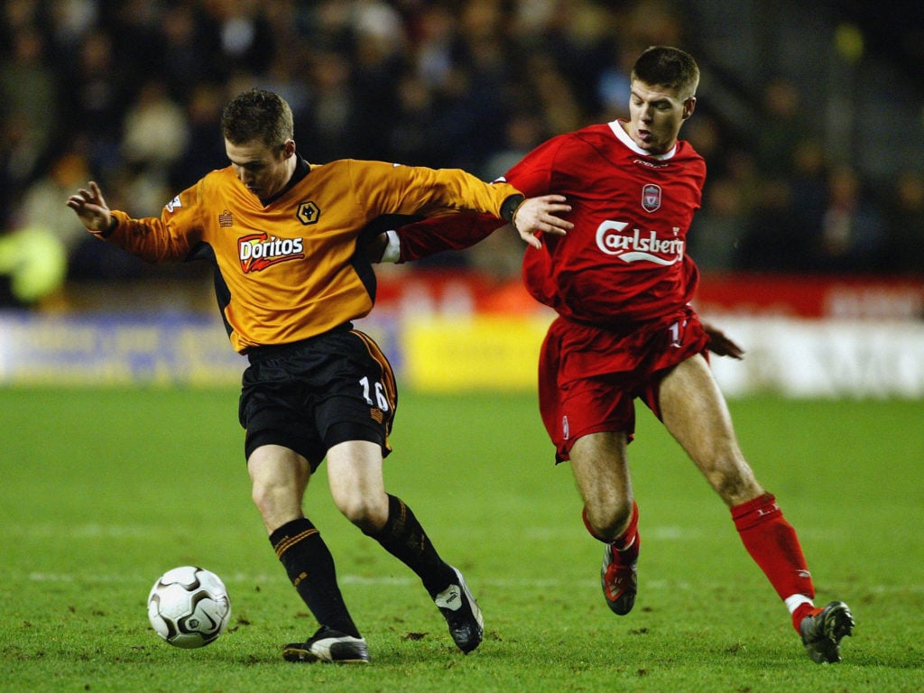 Kenny Miller of Wolverhampton Wanderers holds off Steven Gerrard of Liverpool