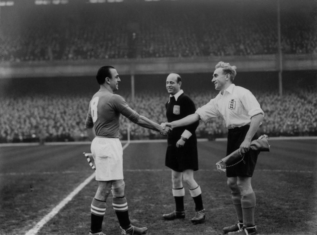 Lauro Amado, the Swiss captain, shaking hands with England captain and Wolves player Billy Wright