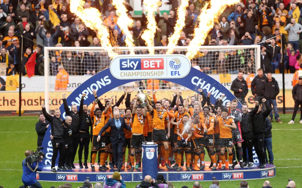 Wolverhampton Wanderers players celebrate with the EFL Sky Bet trophy