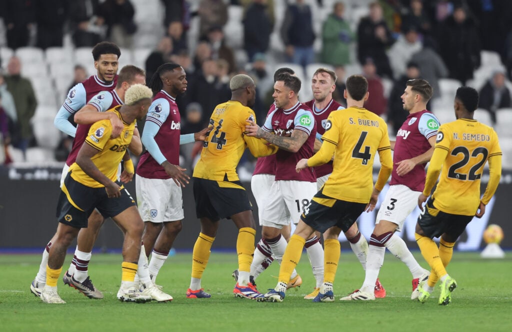 Wolves players have an exchange with West Ham players.