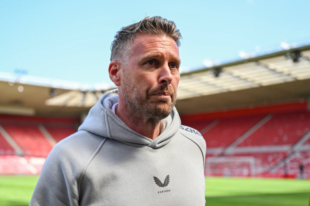 Middlesbrough manager Rob Edwards looks on.