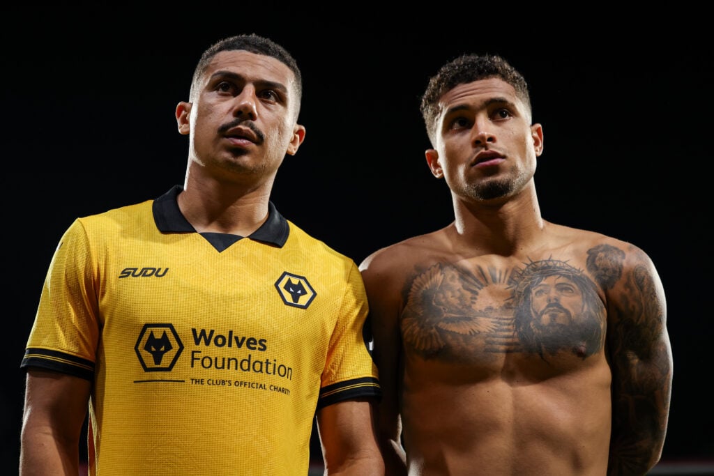 Wolves midfielders Andre and Joao Gomes look on.