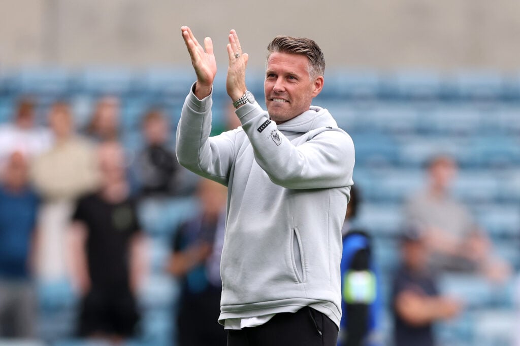 Rob Edwards applauds fans.