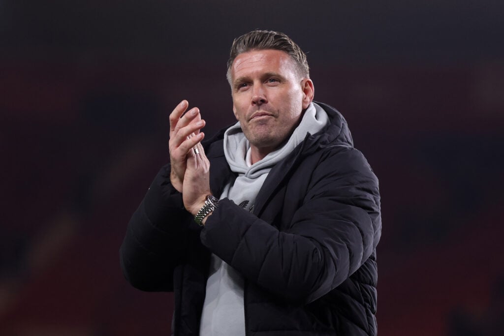 Rob Edwards claps fans.