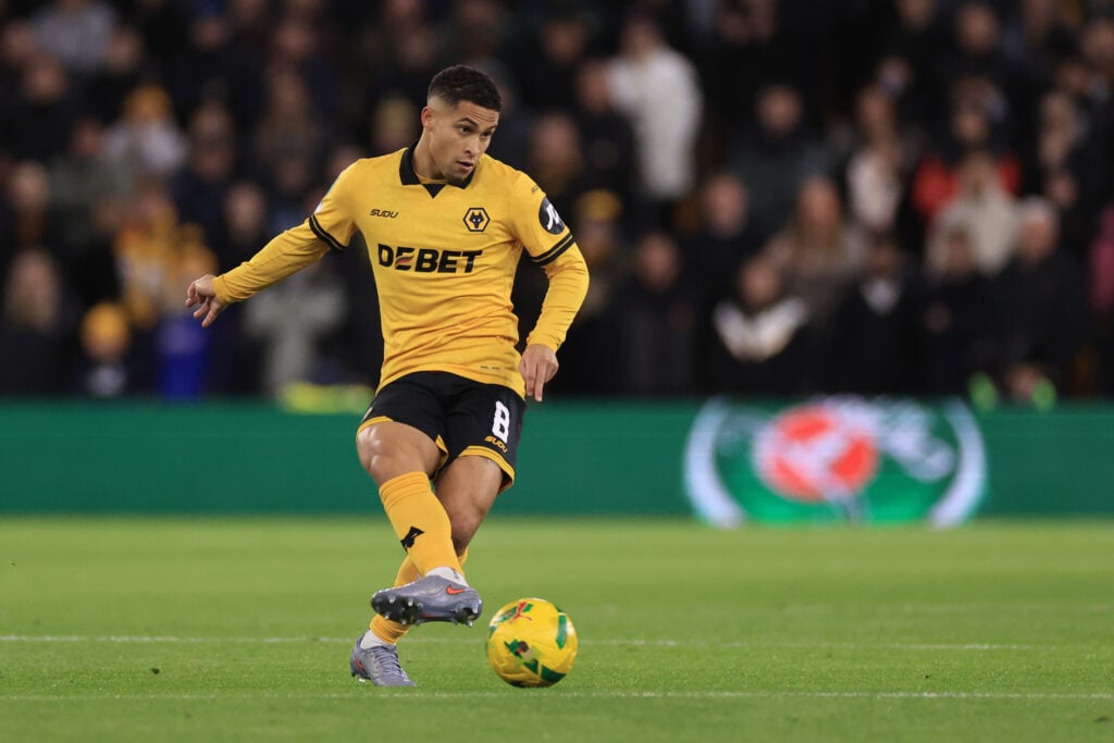 Joao Gomes plays a pass for Wolves.