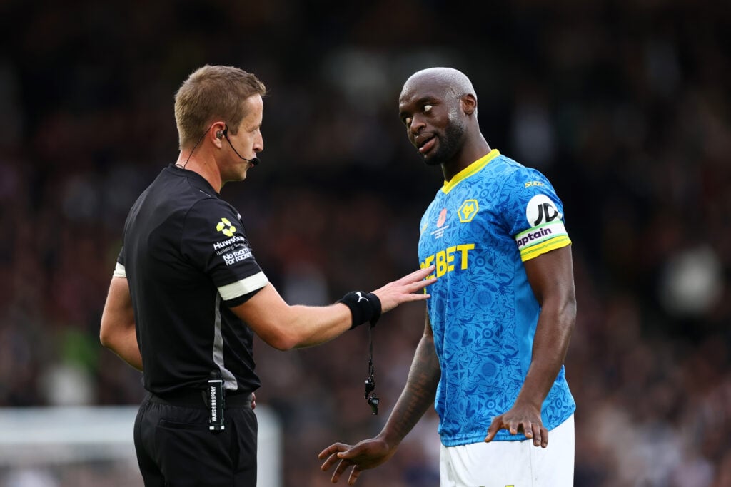 Toti Gomes of Wolverhampton Wanderers speaks with referee John Brooks