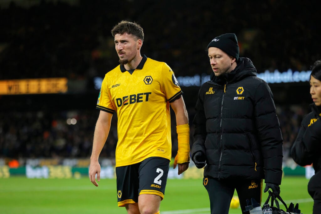 Matt Doherty goes off injured for Wolves against Chelsea.