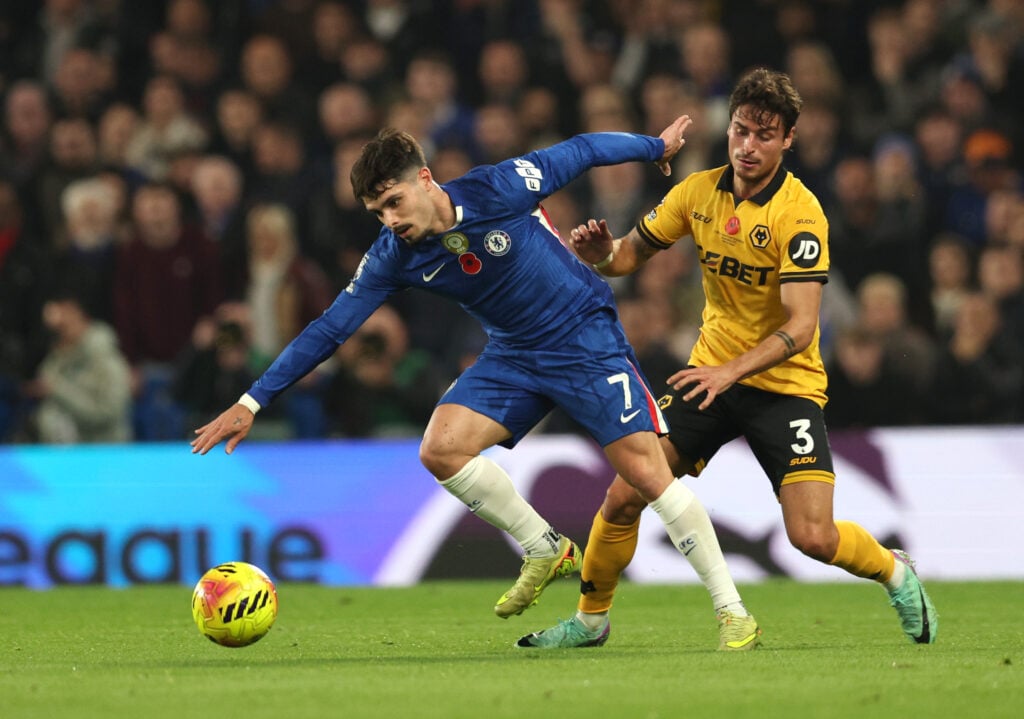 Pedro Neto and Hugo Bueno fight for the ball during Chelsea vs Wolves.