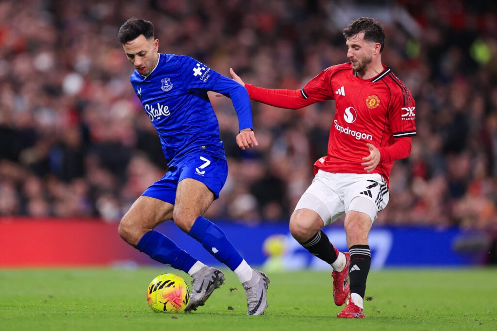 Dwight McNeil shielding the ball from Manchester United's Mason Mount