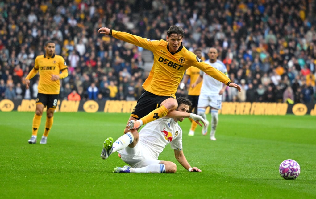 Wolves' Fer Lopez is challenged by a Leeds player.