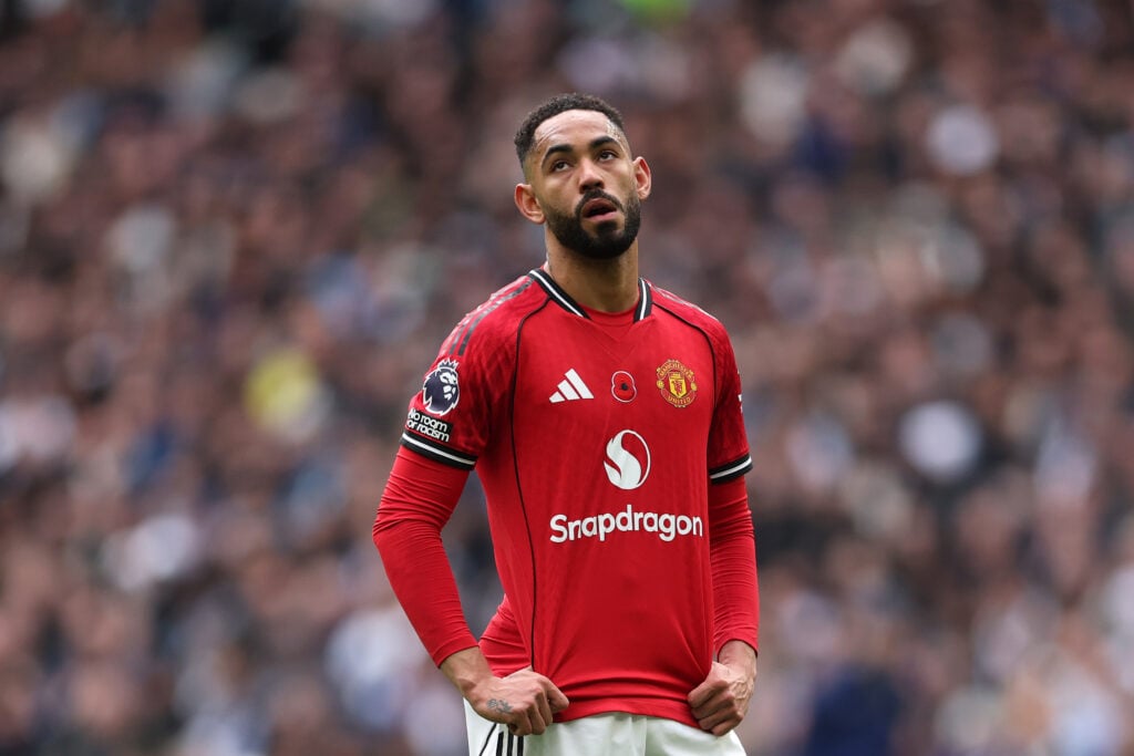 Matheus Cunha puts his hands on his hips for Manchester United.