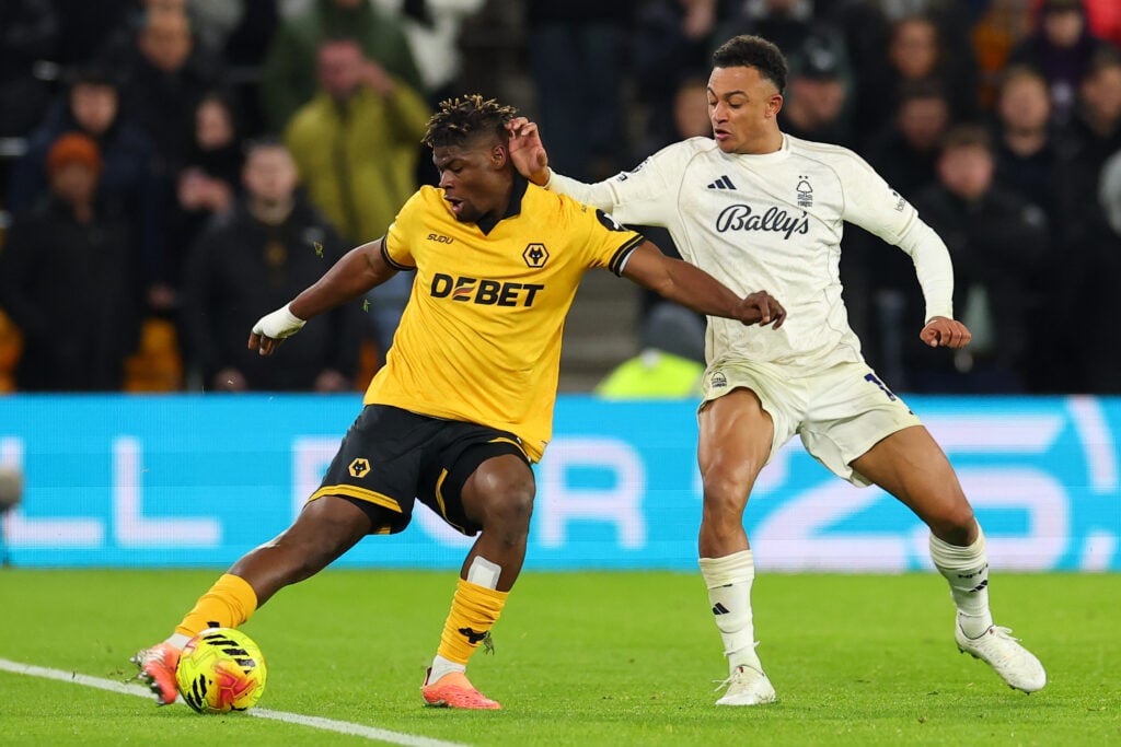 Emmanuel Agbadou clearing the ball from danger for Wolves as Dan Ndoye pressures