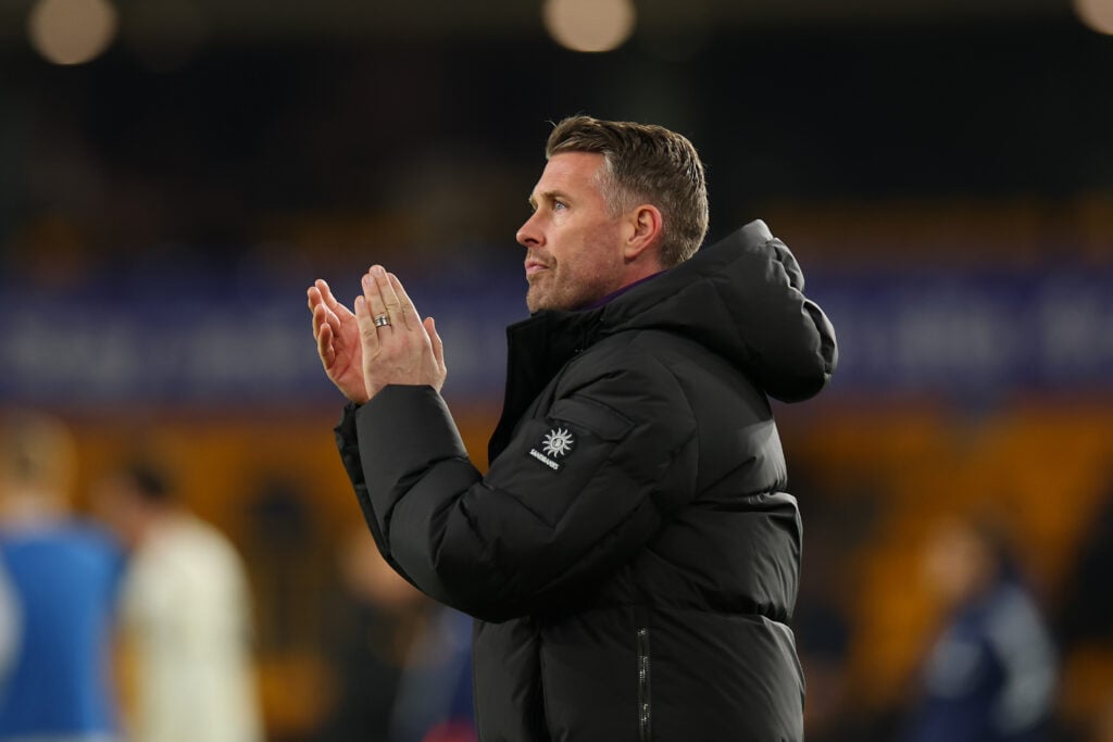 Rob Edwards, manager of Wolverhampton Wanderers, applauds his team's supporters