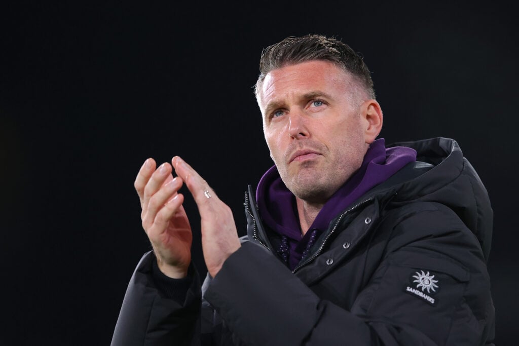 Rob Edwards looks on.