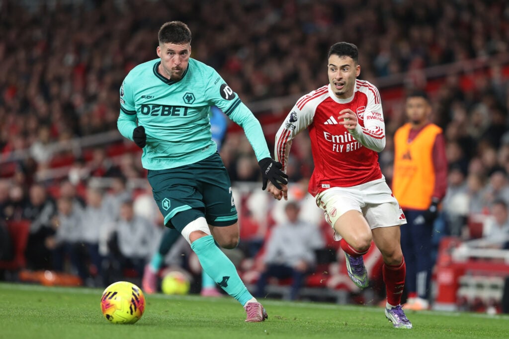 Matt Doherty running with the ball as Gabriel Martinelli chases