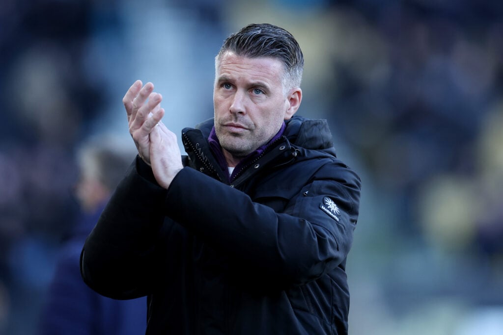 Rob Edwards claps fans.