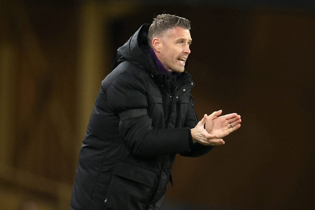 Rob Edwards applauding his Wolves players while giving instructions