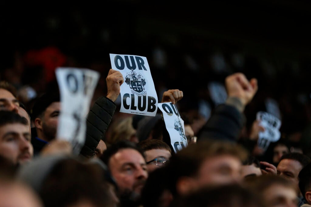 Wolves fans hold up 'Our Club' posters.