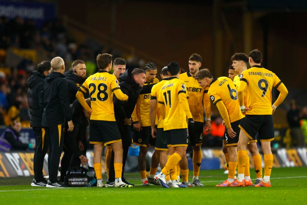 Rob Edwards gives a team talk to his Wolves players.