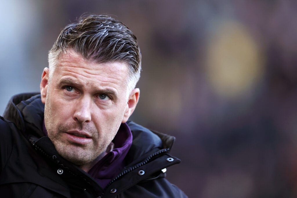 Rob Edwards looks on.