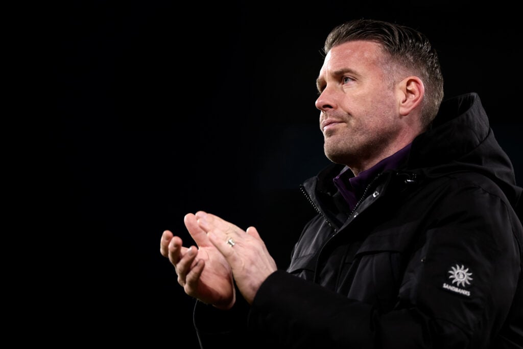 Rob Edwards applauds Wolves fans.