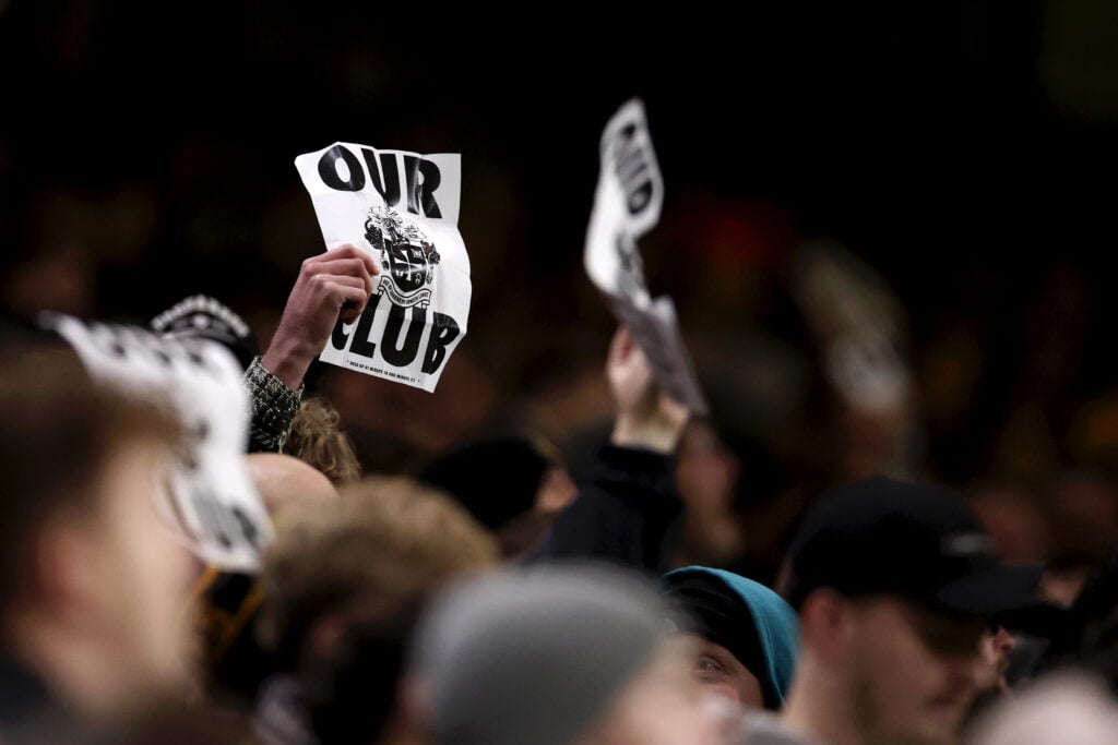 Wolves fans hold up 'Our Club' signs.