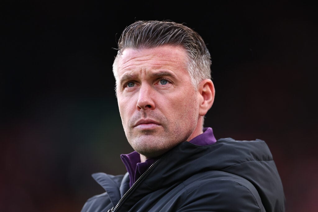 Rob Edwards looks on.