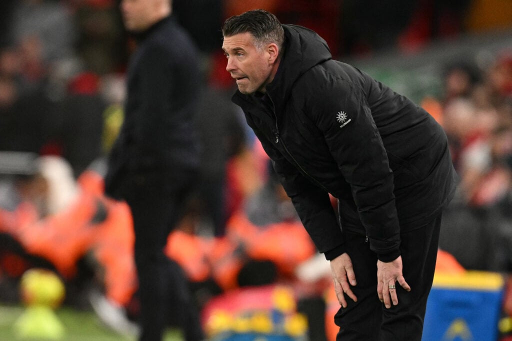 Rob Edwards with his hands on his knees vs Liverpool